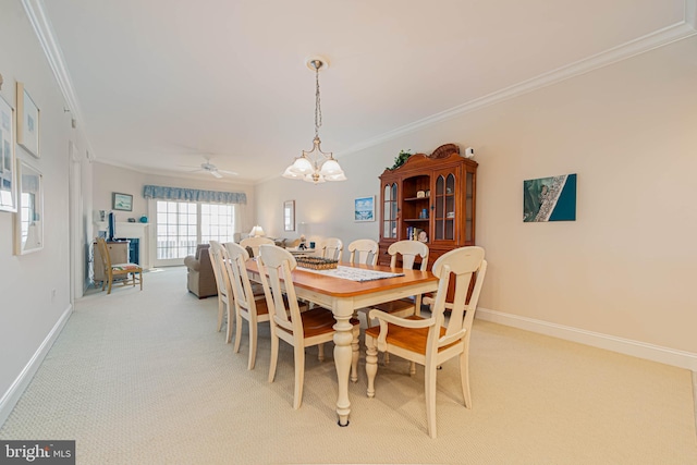 301 14th St Unit 304, Ocean City, MD 21842 - carpeted dining room featuring ornamental molding, a chandelier, and a ceiling fan
