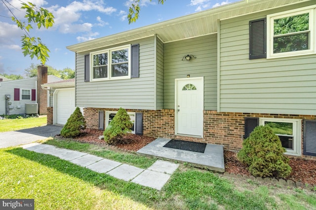 2110 Douglas Dr, Carlisle, PA 17013 - doorway to property with driveway, a yard, and brick siding