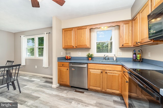 2110 Douglas Dr, Carlisle, PA 17013 - kitchen with black appliances, light wood finished floors, ceiling fan, dark countertops, and brown cabinets