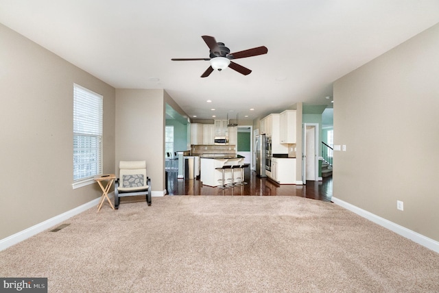 10535 Windlass Run Rd, Baltimore, MD 21220 - living room featuring dark carpet, ceiling fan, stairs, and recessed lighting