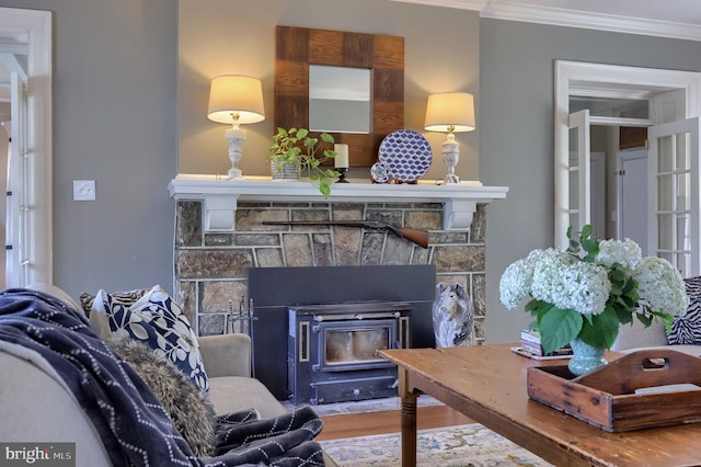 152 Main St, New Providence, PA 17560 - living room featuring crown molding, a stone fireplace, and wood finished floors