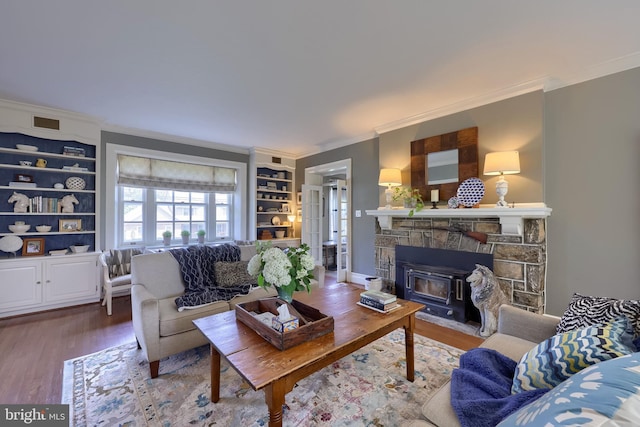 152 Main St, New Providence, PA 17560 - living area with crown molding, wood finished floors, a fireplace, and built in features