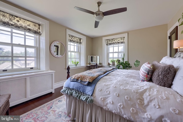 152 Main St, New Providence, PA 17560 - bedroom featuring radiator heating unit, multiple windows, wood finished floors, and a ceiling fan