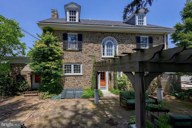 152 Main St, New Providence, PA 17560 - view of front facade with a patio area, stone siding, a pergola, an outdoor hangout area, and a chimney