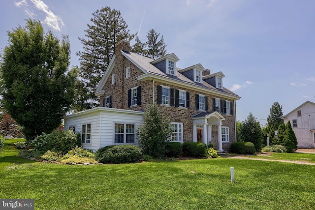 152 Main St, New Providence, PA 17560 - colonial inspired home with a front lawn, stone siding, and a chimney