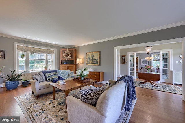 152 Main St, New Providence, PA 17560 - living area featuring crown molding, wood finished floors, a chandelier, and french doors