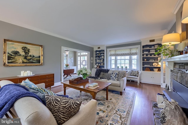 152 Main St, New Providence, PA 17560 - living room featuring crown molding, a fireplace, wood finished floors, and built in shelves