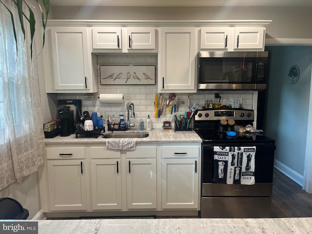 499 Prospect Rd, Warminster, PA 18974 - kitchen with stainless steel appliances, decorative backsplash, white cabinetry, and dark wood finished floors