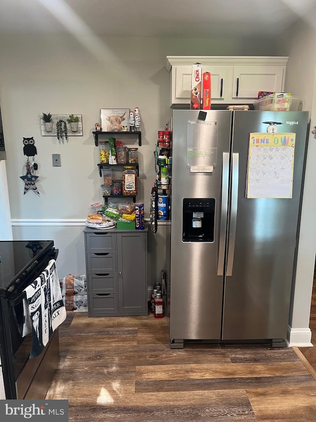 499 Prospect Rd, Warminster, PA 18974 - kitchen with stainless steel fridge, dark wood-type flooring, white cabinets, and black / electric stove