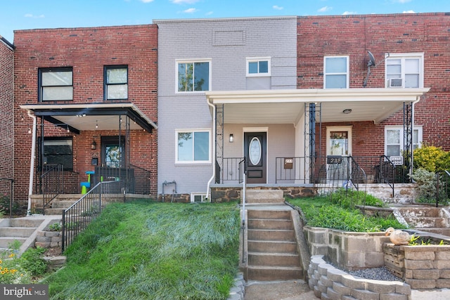 233 S Clinton St, Baltimore, MD 21224 - townhome / multi-family property featuring brick siding and a porch