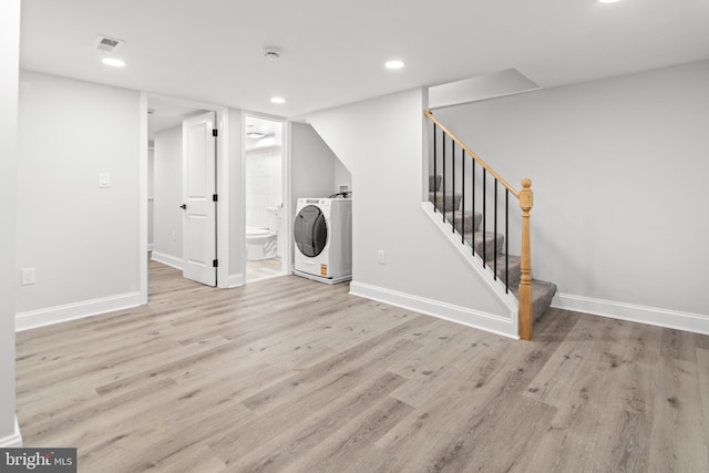 233 S Clinton St, Baltimore, MD 21224 - unfurnished living room featuring wood finished floors, stairs, recessed lighting, and washing machine and clothes dryer