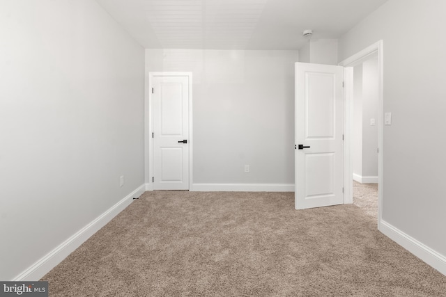 233 S Clinton St, Baltimore, MD 21224 - carpeted spare room with baseboards and a smoke detector