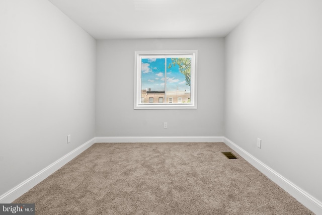 233 S Clinton St, Baltimore, MD 21224 - carpeted empty room with baseboards