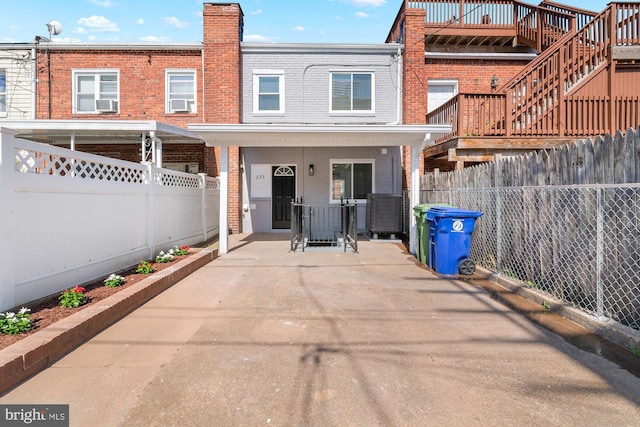 233 S Clinton St, Baltimore, MD 21224 - rear view of house with brick siding and a fenced backyard