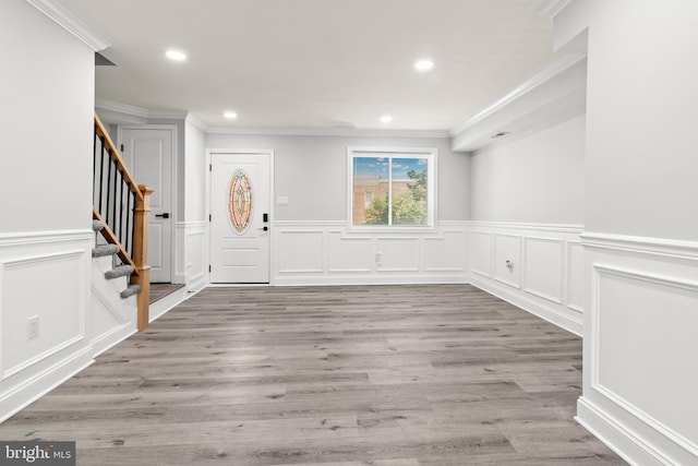 233 S Clinton St, Baltimore, MD 21224 - foyer entrance featuring ornamental molding, a decorative wall, recessed lighting, stairway, and wood finished floors
