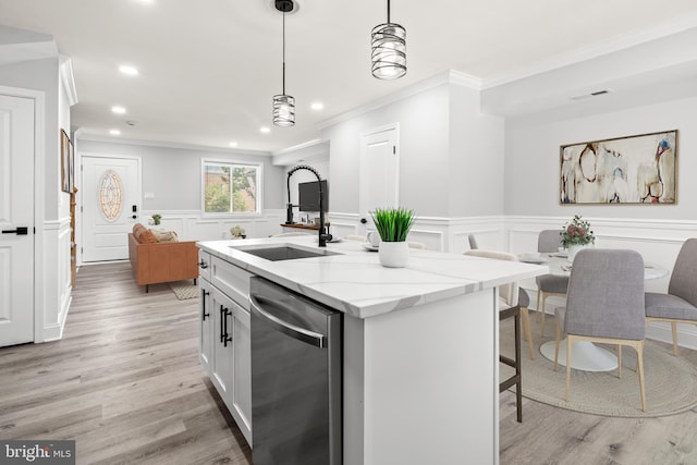 233 S Clinton St, Baltimore, MD 21224 - kitchen with stainless steel dishwasher, crown molding, light wood-type flooring, recessed lighting, and a decorative wall