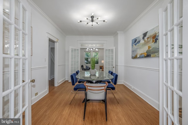 1217 Holbrook St NE, Washington, DC 20002 - dining area featuring french doors, a chandelier, light wood-style floors, and ornamental molding