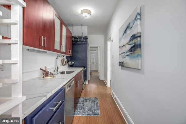 1217 Holbrook St NE, Washington, DC 20002 - kitchen with dishwasher, light wood-style floors, blue cabinetry, glass insert cabinets, and light stone counters