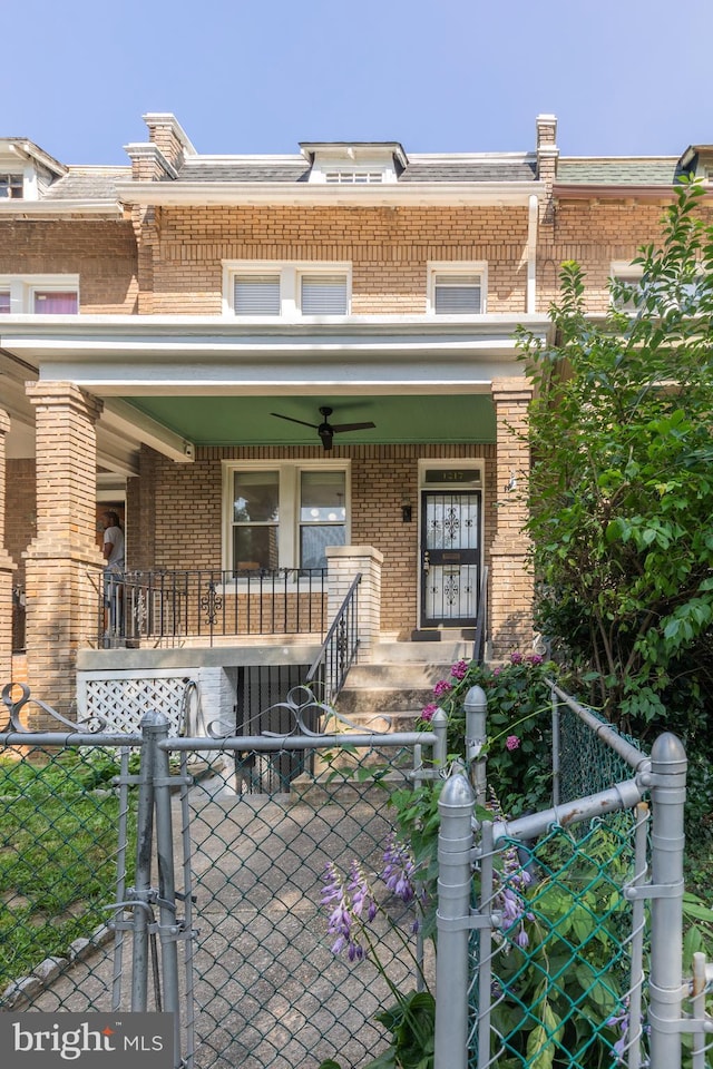 1217 Holbrook St NE, Washington, DC 20002 - multi unit property featuring a porch, brick siding, a gate, and a fenced front yard