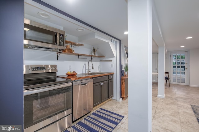 1217 Holbrook St NE, Washington, DC 20002 - kitchen featuring appliances with stainless steel finishes, recessed lighting, wooden counters, open shelves, and light tile patterned floors