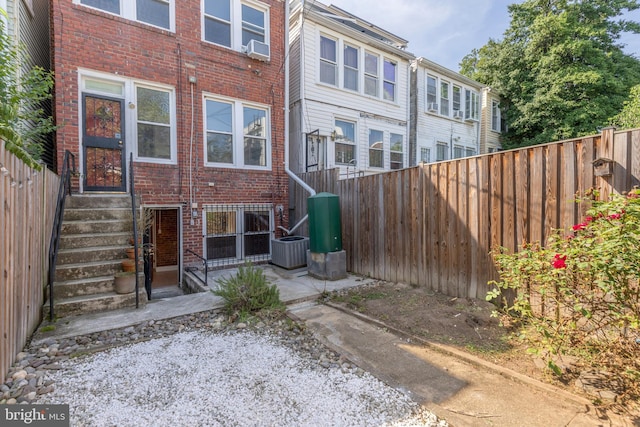 1217 Holbrook St NE, Washington, DC 20002 - rear view of house with entry steps, brick siding, and a fenced backyard