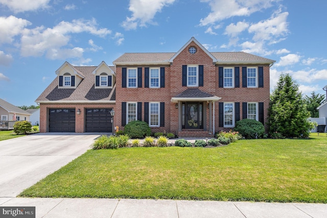 421 Dart Dr, Hanover, PA 17331 - colonial house featuring a front yard, concrete driveway, brick siding, and a garage