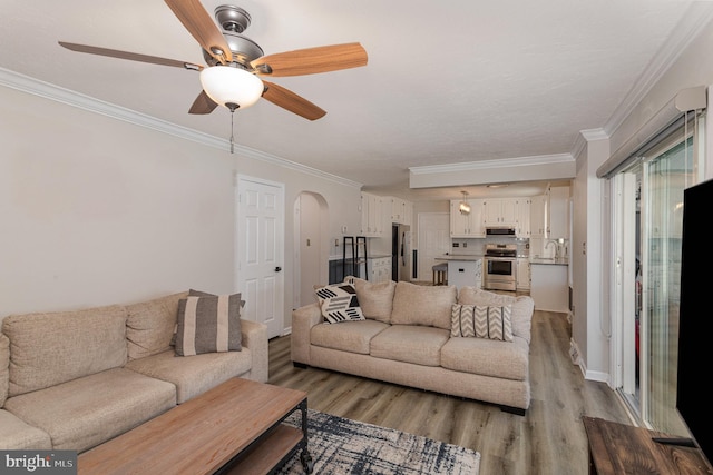 421 Dart Dr, Hanover, PA 17331 - living area featuring arched walkways, crown molding, ceiling fan, and wood finished floors