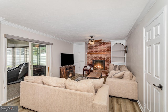 421 Dart Dr, Hanover, PA 17331 - living area with light wood-style floors, ceiling fan, crown molding, a fireplace, and a textured ceiling