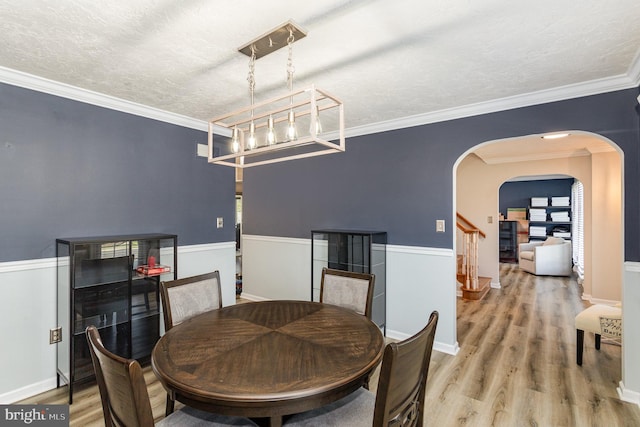 421 Dart Dr, Hanover, PA 17331 - dining space with arched walkways, wood finished floors, stairway, a chandelier, and ornamental molding