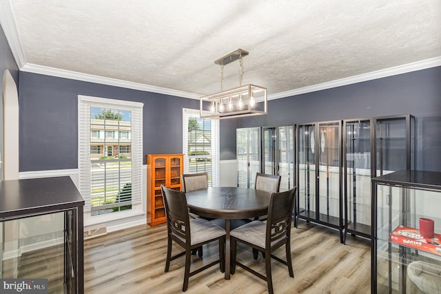 421 Dart Dr, Hanover, PA 17331 - dining space featuring wood finished floors, a textured ceiling, crown molding, arched walkways, and wainscoting