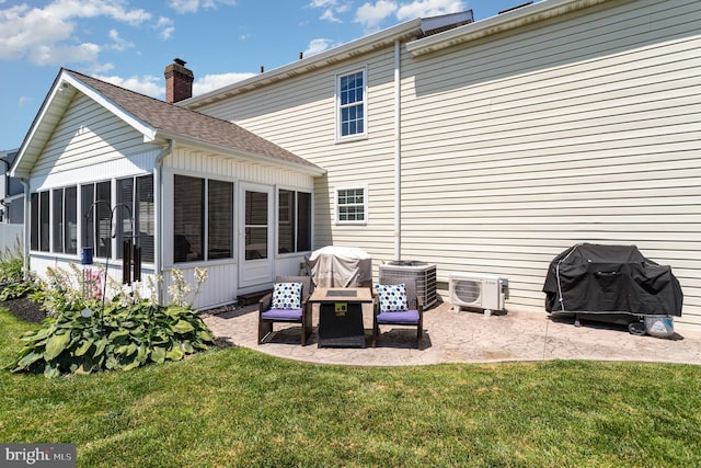 421 Dart Dr, Hanover, PA 17331 - rear view of house featuring a sunroom, a patio, and a lawn