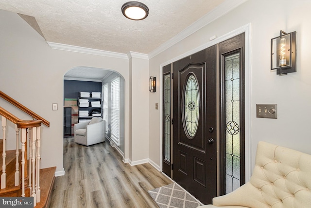 421 Dart Dr, Hanover, PA 17331 - foyer entrance with arched walkways, light wood finished floors, a textured ceiling, ornamental molding, and stairs