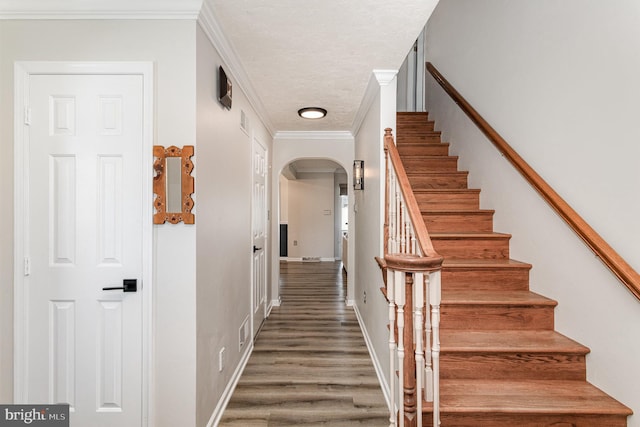 421 Dart Dr, Hanover, PA 17331 - staircase with arched walkways, ornamental molding, wood finished floors, and a textured ceiling