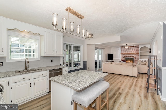 421 Dart Dr, Hanover, PA 17331 - kitchen with dishwasher, healthy amount of natural light, light wood finished floors, white cabinetry, and a textured ceiling