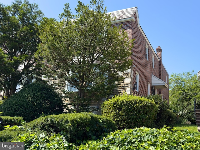 8016 Hollis St, Philadelphia, PA 19150 - view of home's exterior with brick siding and a high end roof