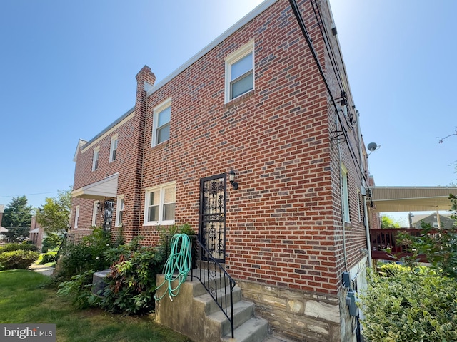 8016 Hollis St, Philadelphia, PA 19150 - rear view of property with brick siding and a chimney