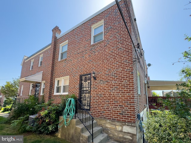 8016 Hollis St, Philadelphia, PA 19150 - view of side of property featuring brick siding and a chimney
