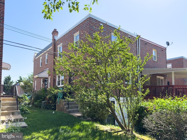 8016 Hollis St, Philadelphia, PA 19150 - view of side of property with brick siding and a yard