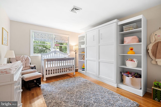 14 Birchall Dr, Haddonfield, NJ 08033 - bedroom featuring light wood-style floors and a crib
