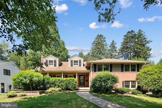 14 Birchall Dr, Haddonfield, NJ 08033 - split level home featuring brick siding, a front yard, and a chimney