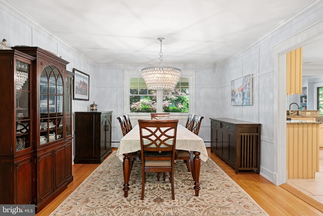 14 Birchall Dr, Haddonfield, NJ 08033 - dining room featuring a chandelier, light wood-style flooring, baseboard heating, crown molding, and a decorative wall