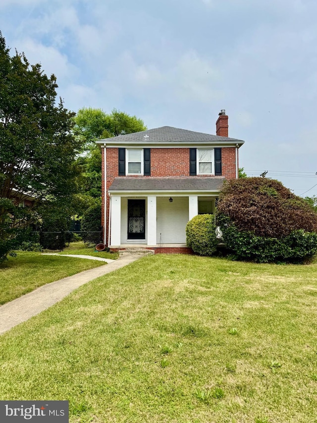 3913 Loch Raven Blvd, Baltimore, MD 21218 - view of front of property with a chimney, a front lawn, and brick siding