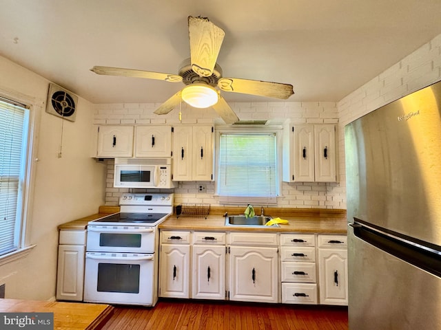 3913 Loch Raven Blvd, Baltimore, MD 21218 - kitchen with white appliances, white cabinets, backsplash, a ceiling fan, and dark wood-style flooring