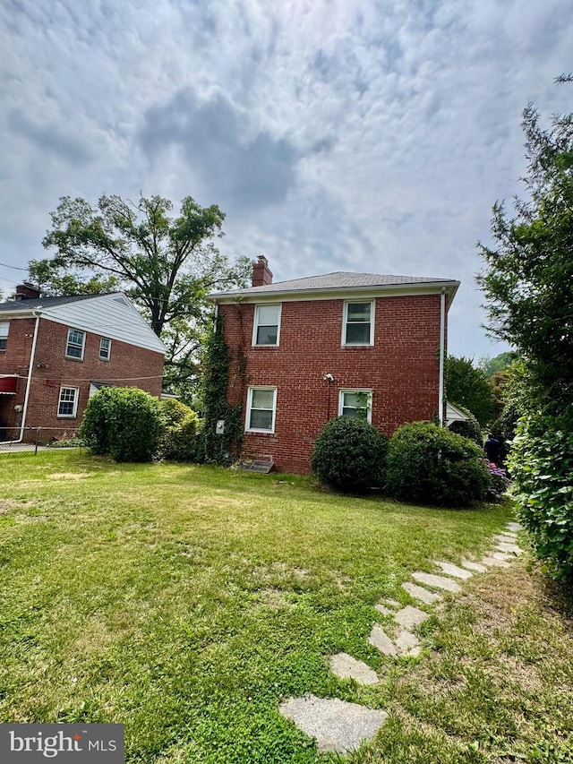 3913 Loch Raven Blvd, Baltimore, MD 21218 - view of home's exterior with a chimney, a lawn, and brick siding