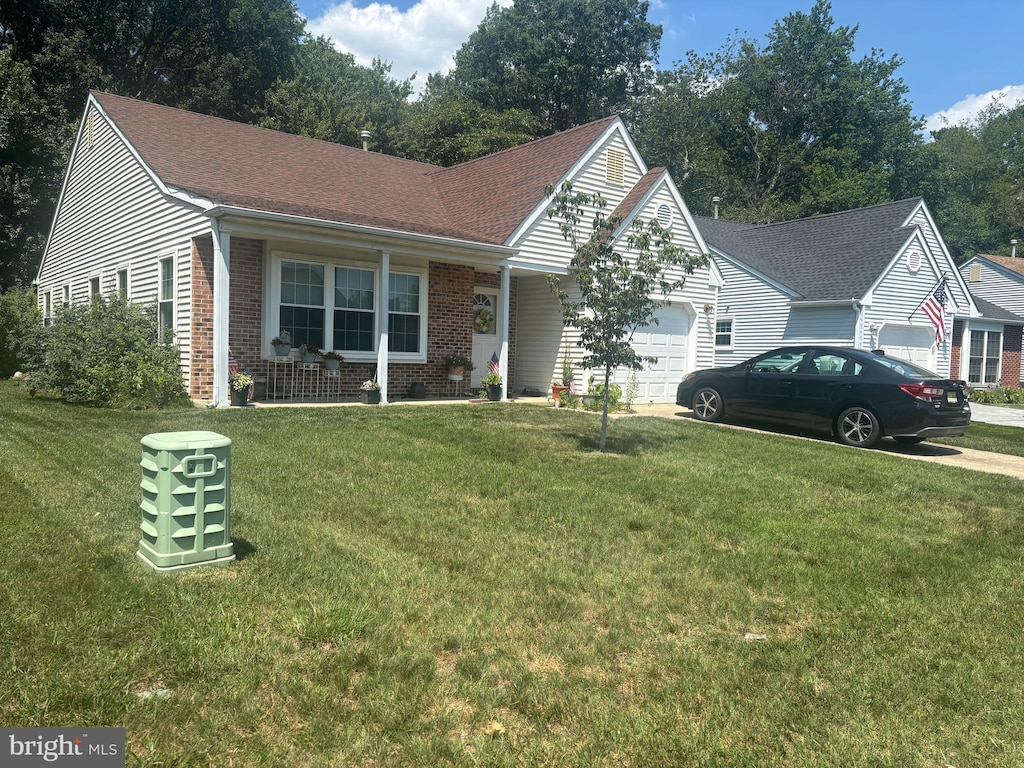 617 Trinidad Blvd, Williamstown, NJ 08094 - ranch-style house with an attached garage, brick siding, a front yard, and driveway