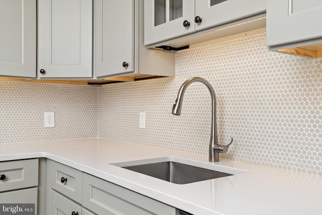 5 Madison St, Princeton, NJ 08542 - kitchen featuring light countertops, gray cabinetry, tasteful backsplash, and glass insert cabinets
