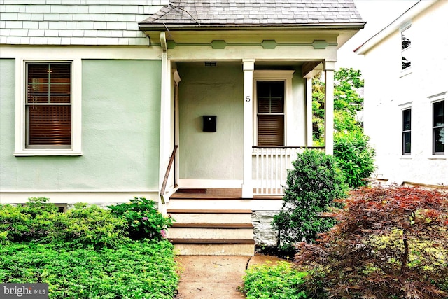 5 Madison St, Princeton, NJ 08542 - doorway to property featuring a porch, stucco siding, and a shingled roof
