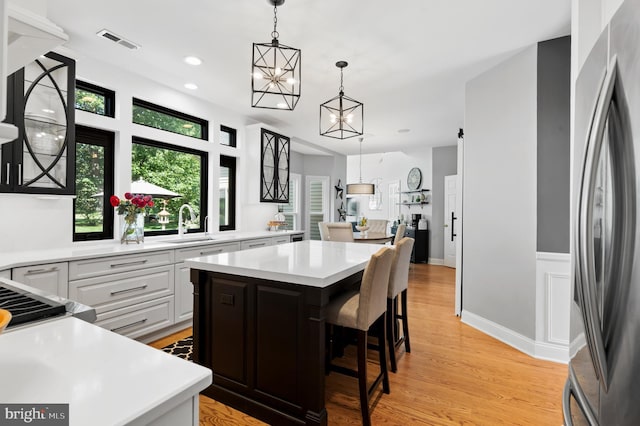 75 Bittersweet Dr, Doylestown, PA 18901 - kitchen with freestanding refrigerator, a center island, light countertops, pendant lighting, and recessed lighting
