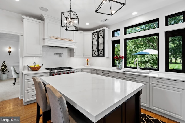 75 Bittersweet Dr, Doylestown, PA 18901 - kitchen featuring a chandelier, light countertops, stainless steel gas stovetop, white cabinetry, and recessed lighting