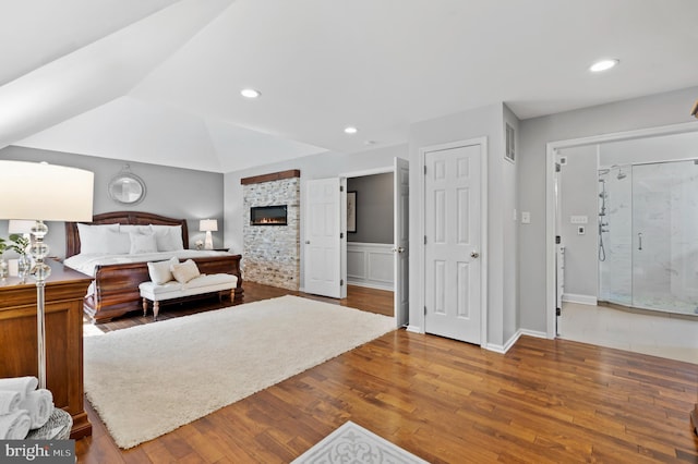 75 Bittersweet Dr, Doylestown, PA 18901 - bedroom featuring wood finished floors, recessed lighting, and a glass covered fireplace